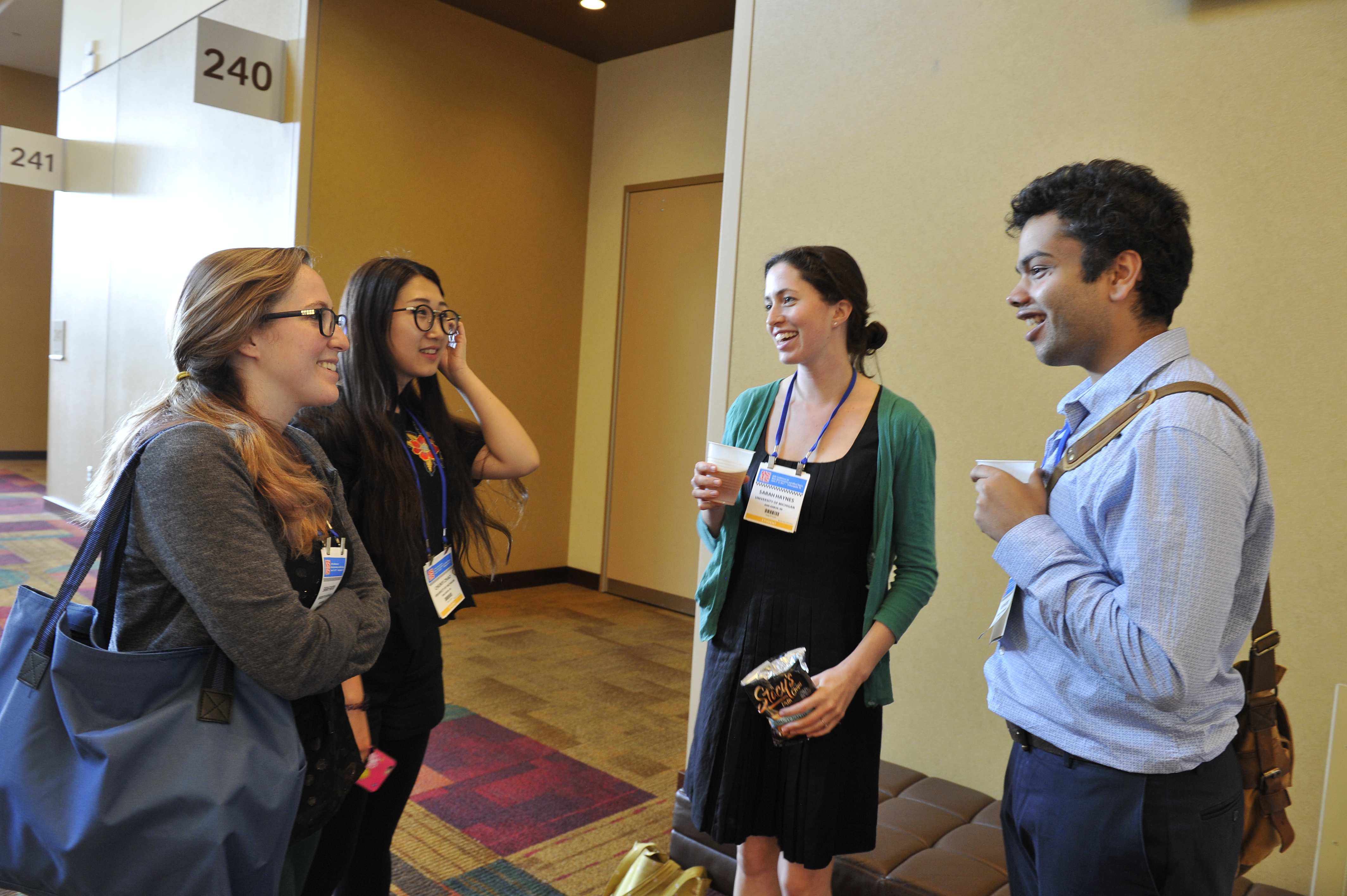 Group of four people engaged in discussion at the annual conference.